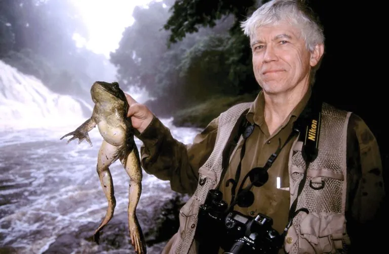 man holding large frog