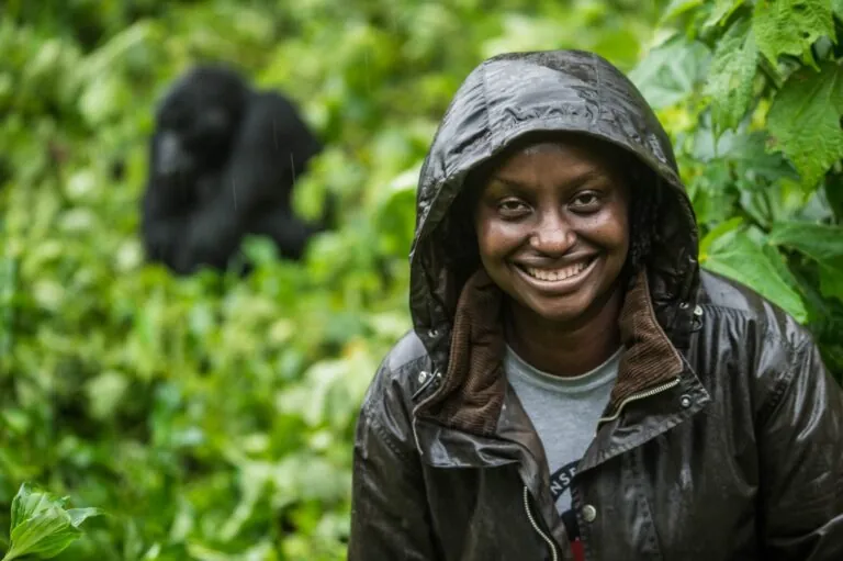 Photos of Gladys Kalema-Zikusoka, in the rain with gorilla in background