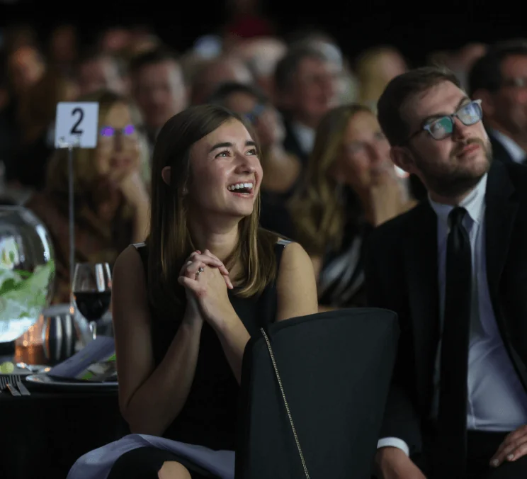 Woman seated and laughing at Indianapolis Prize Gala