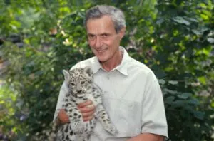 George Schaller Conservationist holding snow leopard cub