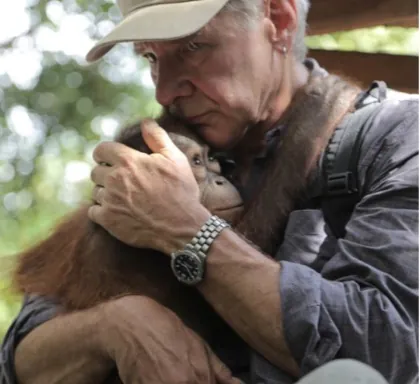 Harrison Ford holding orangutan