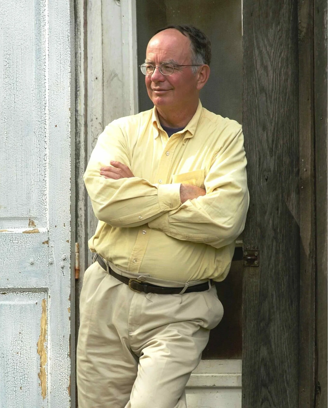 George Archibald leaning on door opening