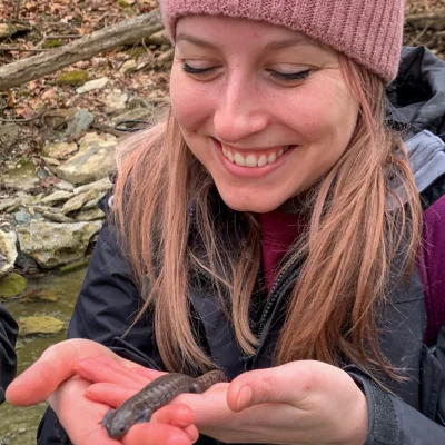 woman holding a streamside salamander