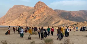 large group cleaning weltands area near mountains
