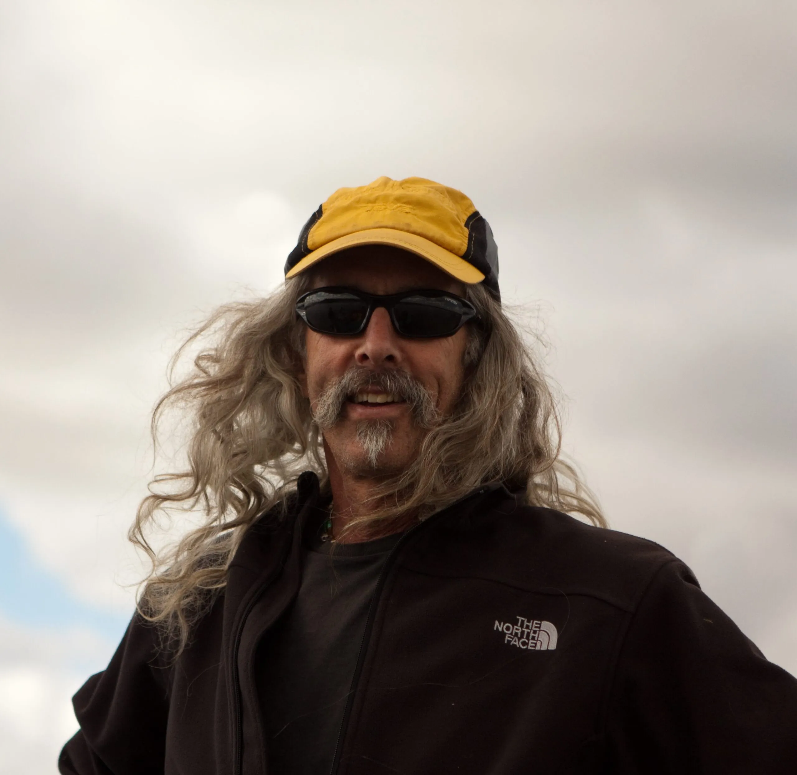 Joel Burger with yellow hat and long hair