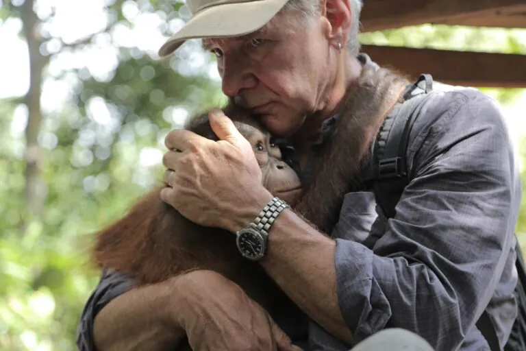 Harrison Ford holding orangutan