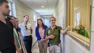 zoo staff pointing through window in the animal medical center at the Indy Zoo