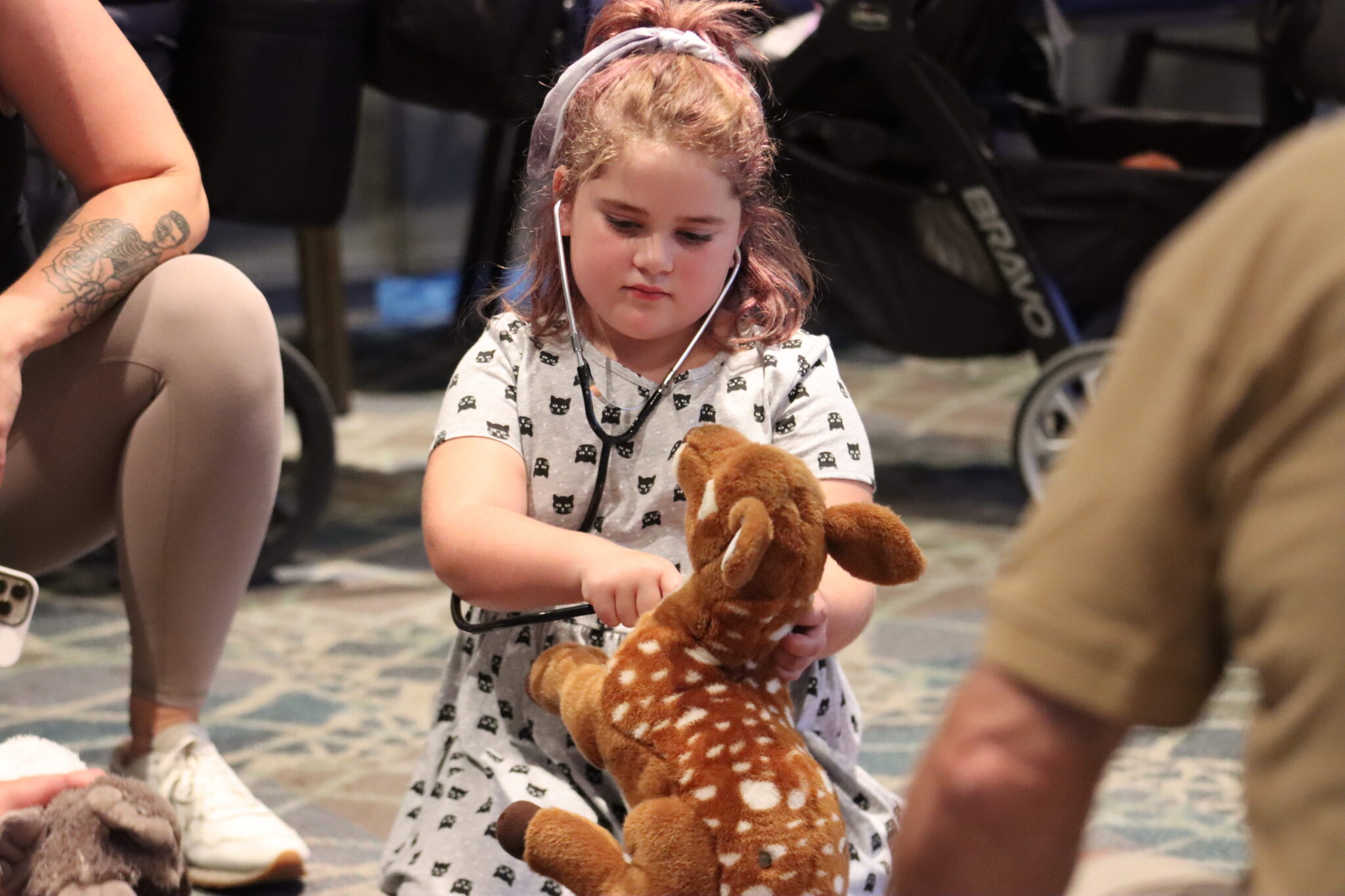 Child with stethoscope and stuffed animal