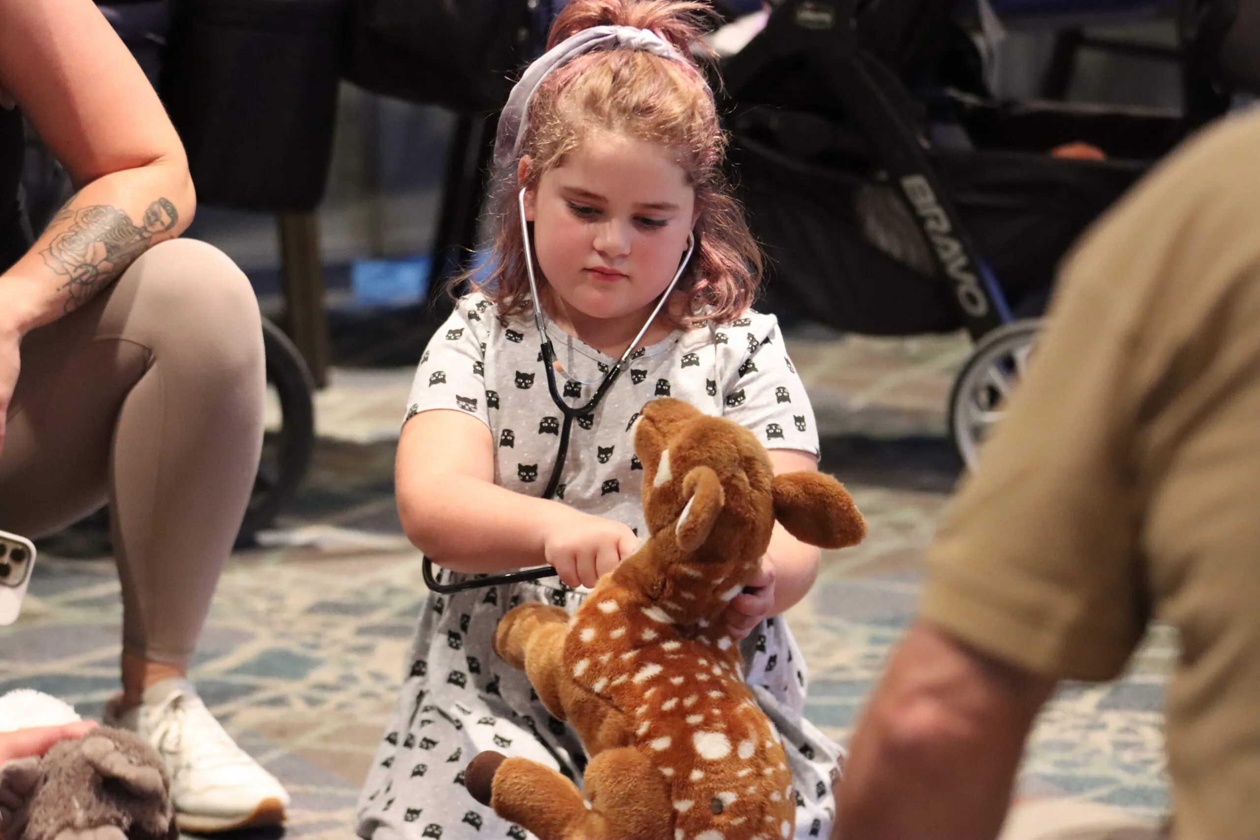 Child with stethoscope and stuffed animal