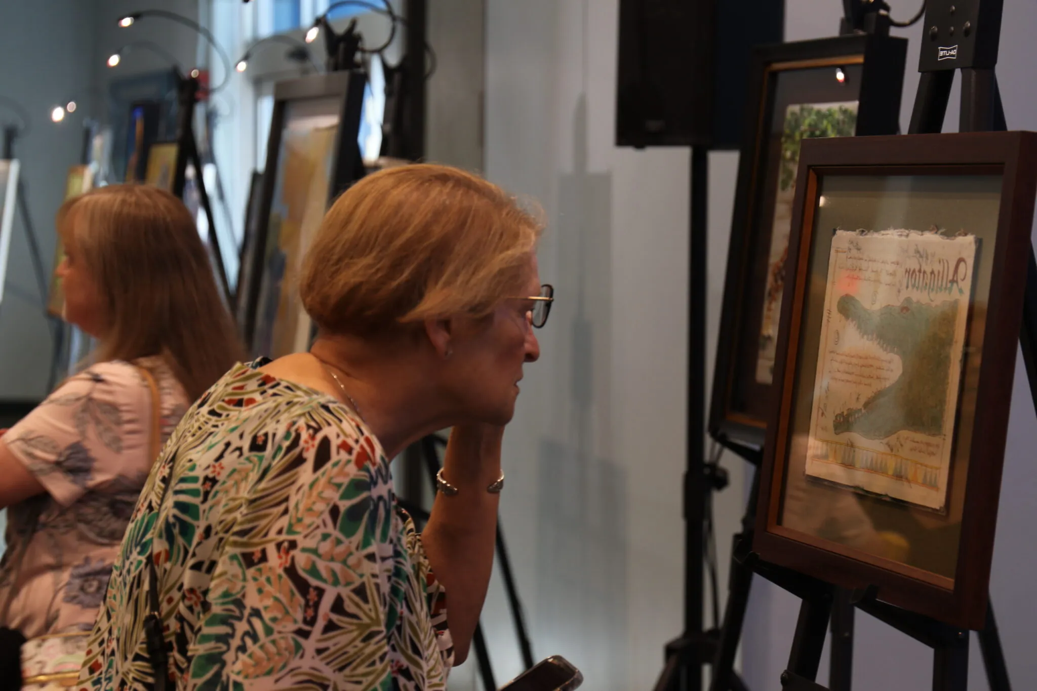 Woman observing Painting from Naturally Inspired Silent Auction