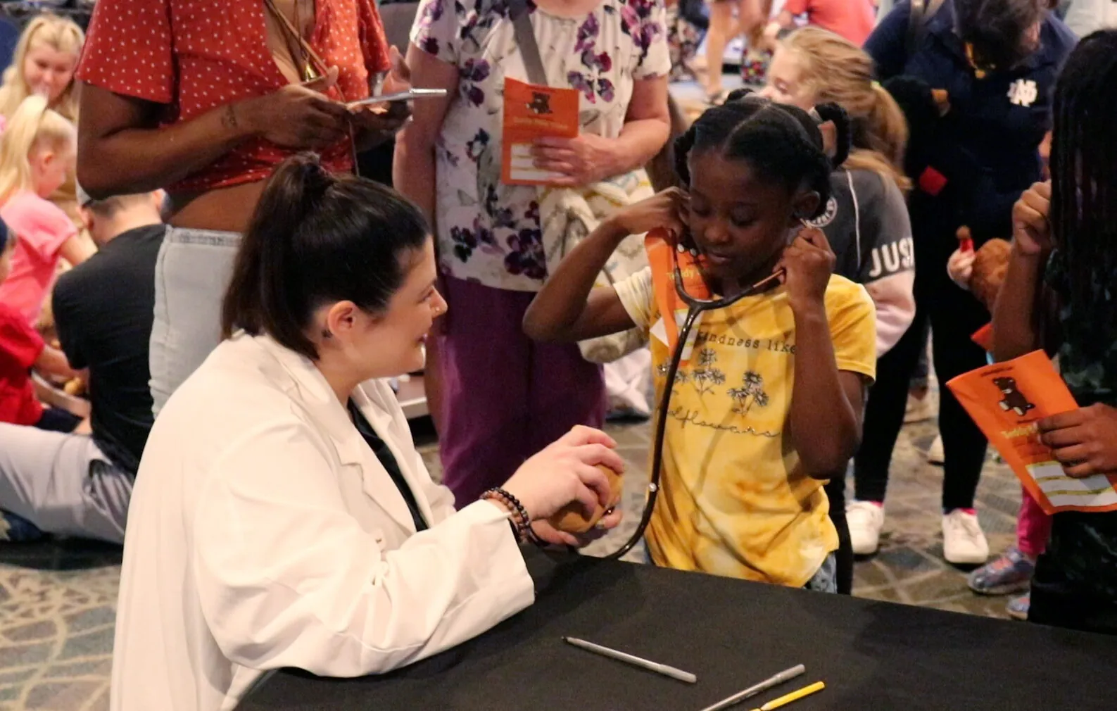 vet and little girl using a stethoscope