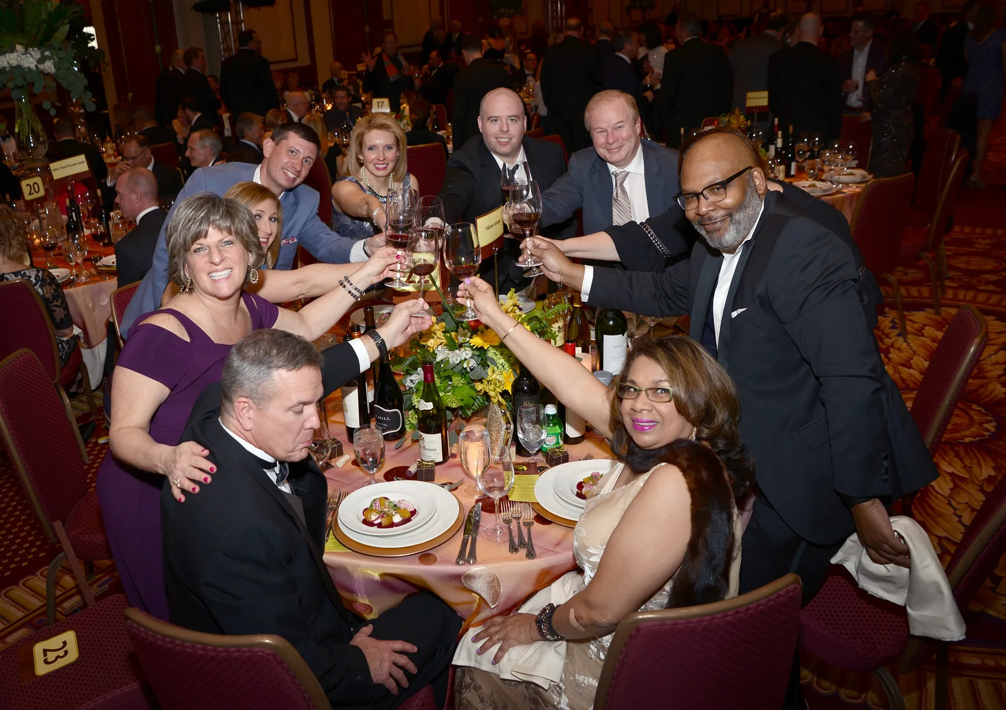 group of guests toasting wine glasses