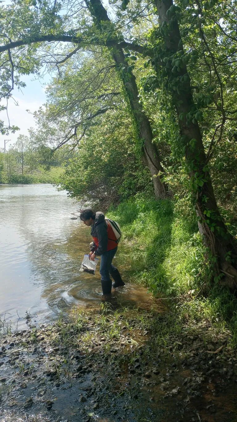 man wading into river, Huzefa Raja