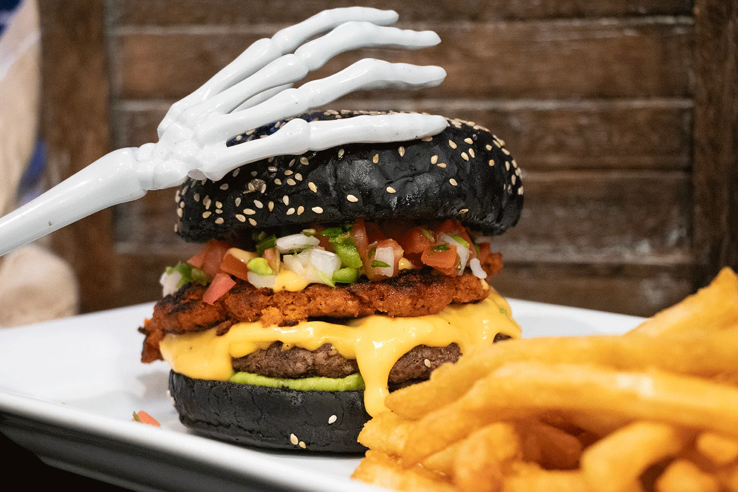 zooboo bruja burger on plate with melty cheese