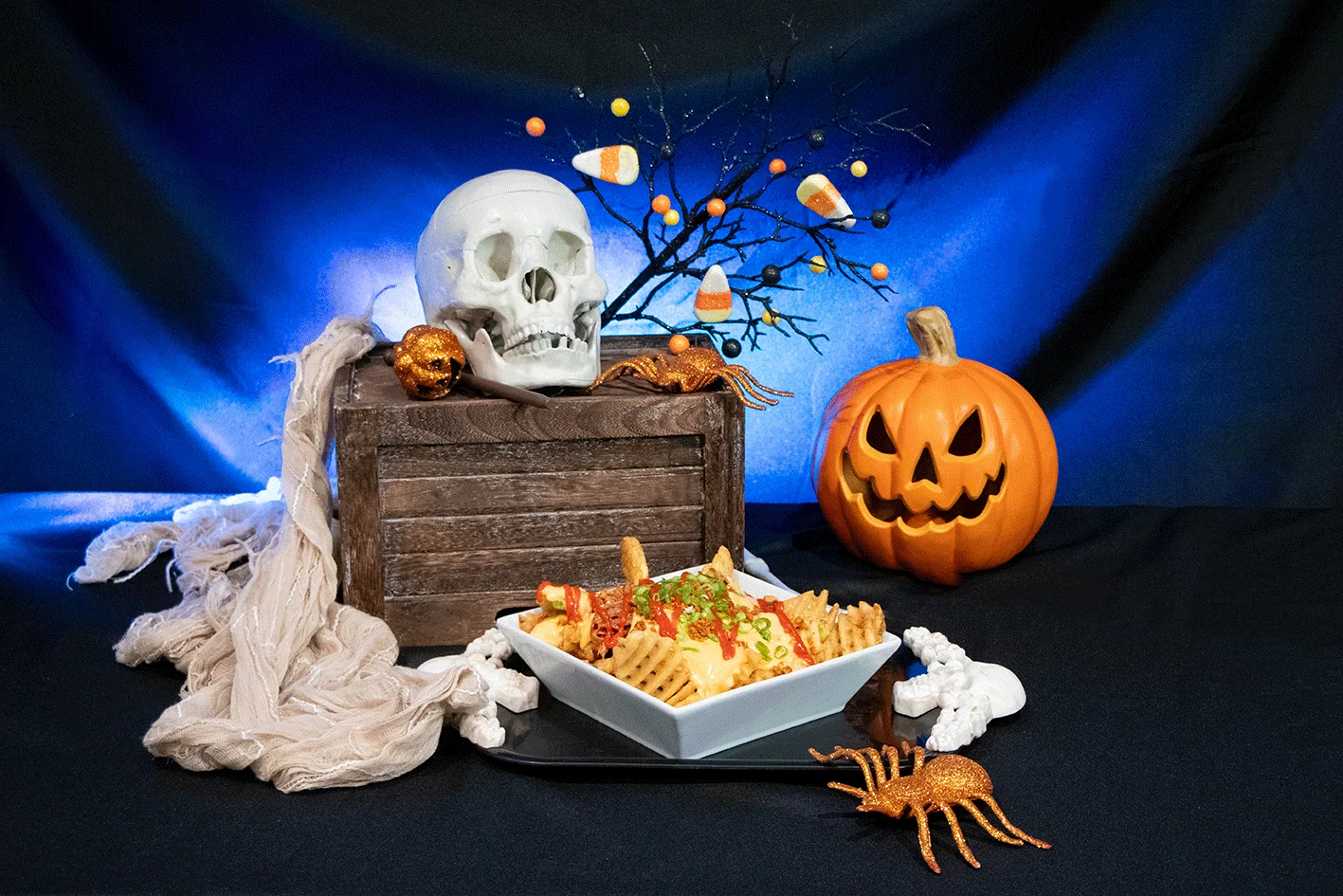 halloween themed waffle fries with skull and pumpkin background