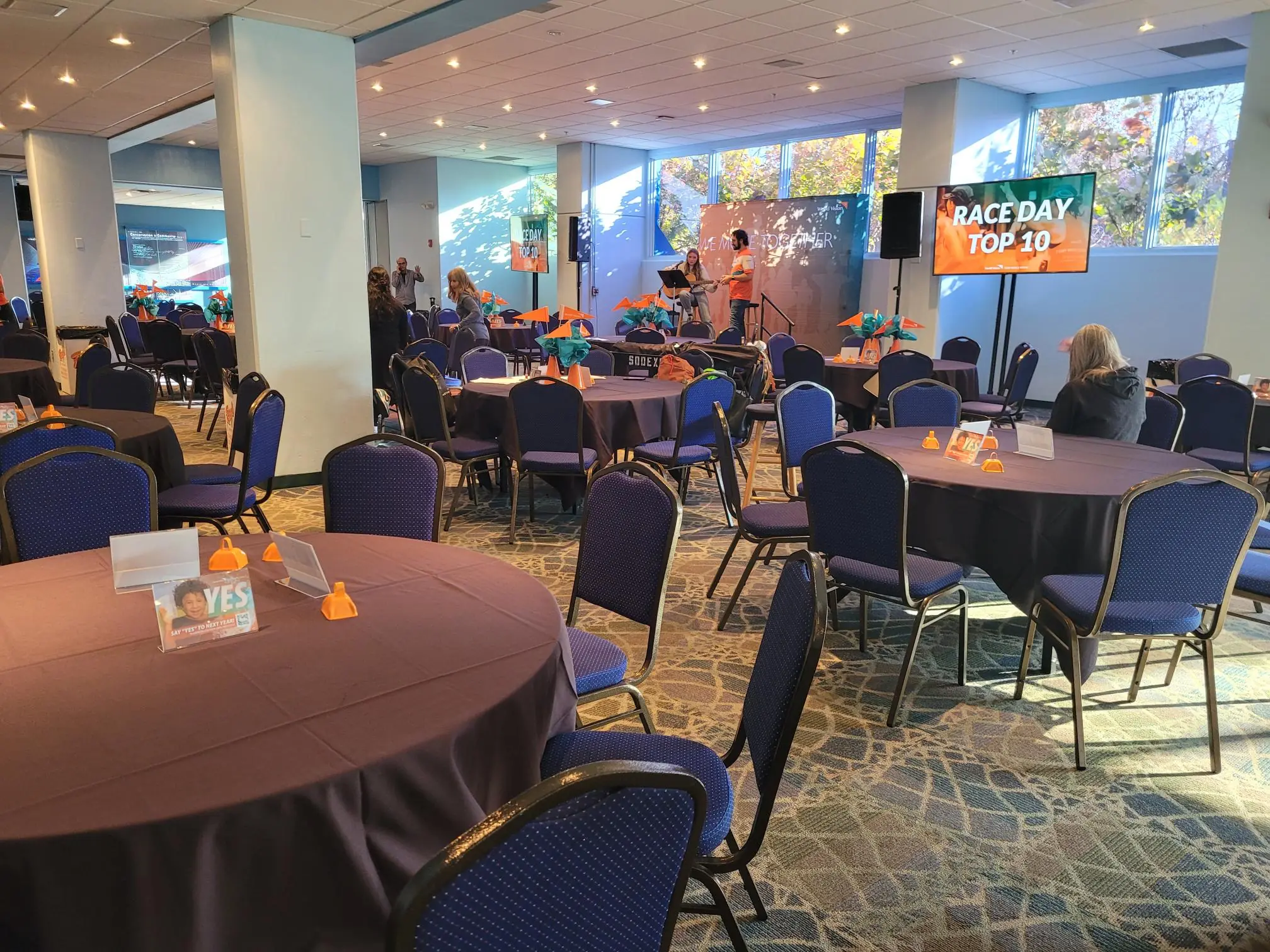 dolphin gallery room setup with tables and monitors for event