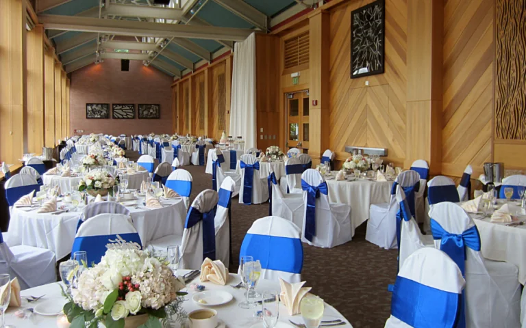 event room set up for wedding with white linens
