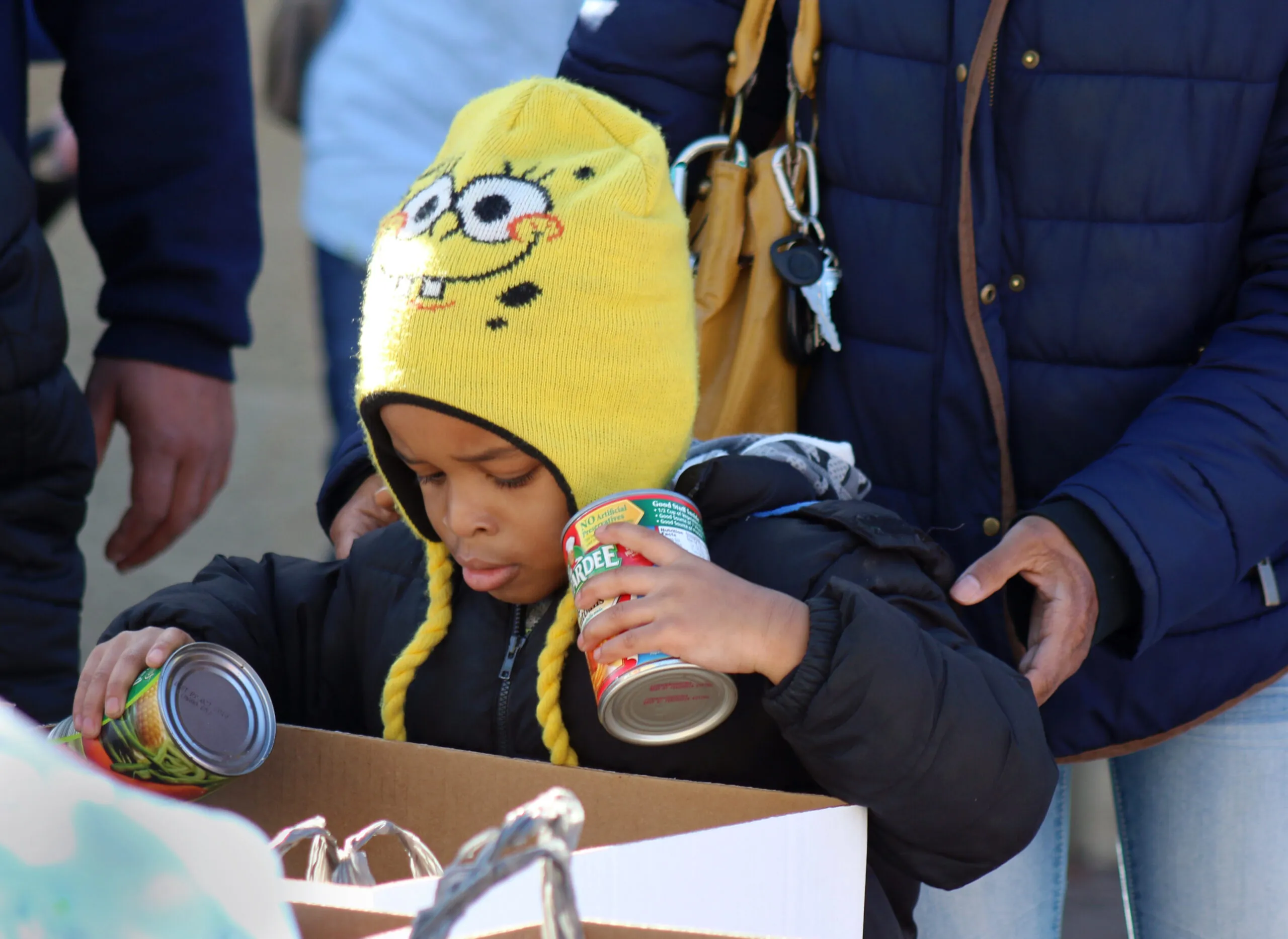 MLK boy donating food